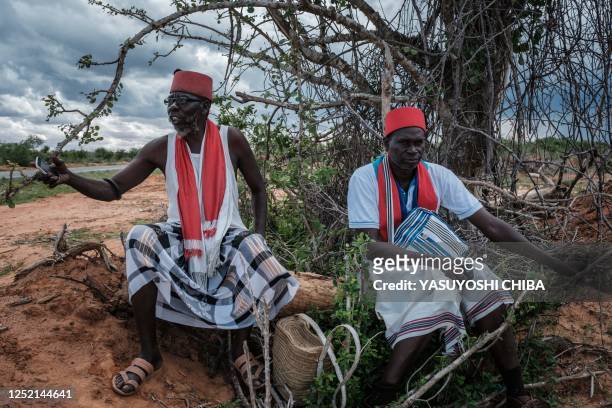 The local spiritual leaders from Kaya-Giriama ethnic group wait for the transport to visit the mass-grave site in the forest in Shakahola, outside...