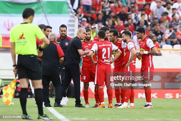 Head coach Yahya Golmohammadi of Persepolis speaks with Saeid Sadeghi of Persepolis during the Persian Gulf Pro League match between Persepolis and...