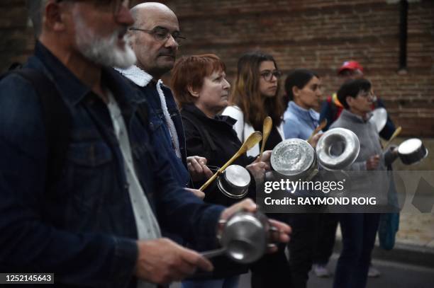 Protesters bang pots and pans, during a demonstration organised by the "Attac" association against the newly signed pension reform and to mark the...