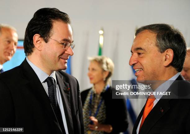 Greek Finance Minister Georgios Papaconstantinou chats with his Cyprus' counterpart Charilaos Stavrakis before attending the second session of an...