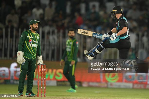 New Zealand's Mark Chapman celebrates after scoring a century as Pakistan's wicketkeeper Mohammad Rizwan looks on during the fifth and final Twenty20...