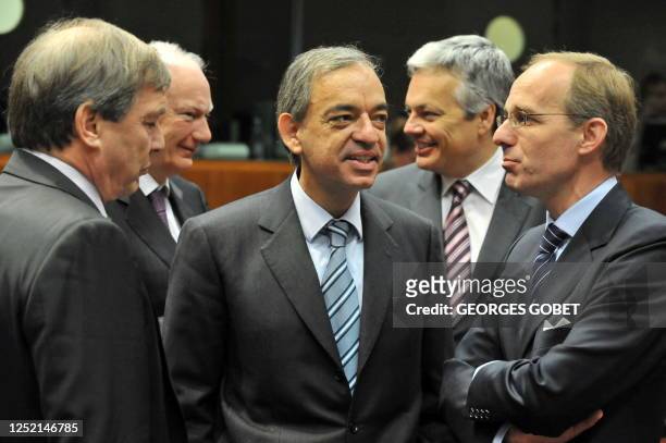 Luxembourg Finance Minister Luc Frieden talks with his Cypriot counterpart Charilaos Stavrakis and an advisor on November 10, 2009 before the start...