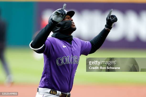 Jurickson Profar of the Colorado Rockies celebrates as he rounds the bases after hitting a solo home run off Cal Quantrill of the Cleveland Guardians...