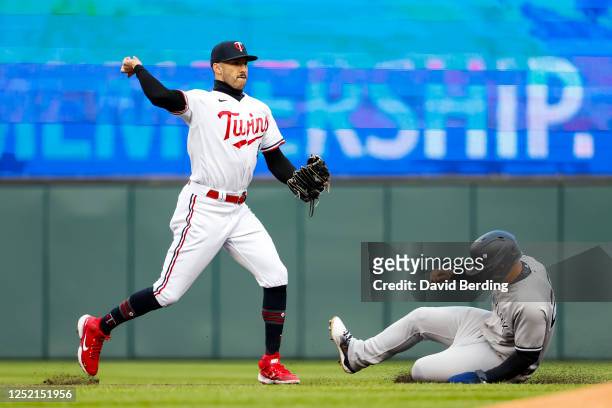 Gleyber Torres of the New York Yankees turns a double play over Carlos Correa of the Minnesota Twins at second base in the second inning at Target...