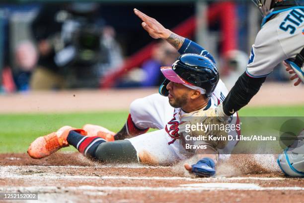 Jacob Stallings of the Miami Marlins tags Eddie Rosario of the Atlanta Braves out at the plate during the second inning at Truist Park on April 24,...