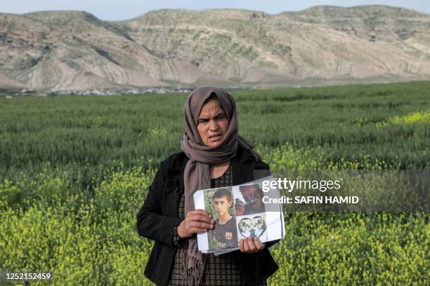 In this picture taken on April 19 Bahar Elias, a 40-year-old displaced Iraqi woman from the Yazidi community, poses for a picture while holding...