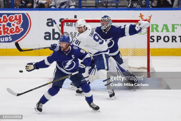 Steven Stamkos and goalie Andrei Vasilevskiy of the Tampa Bay Lightning against John Tavares of the Toronto Maple Leafs during the third period in...