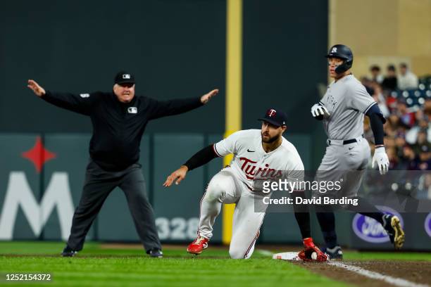 Aaron Judge of the New York Yankees is safe at first base on a throwing error to Joey Gallo of the Minnesota Twins in the eighth inning at Target...
