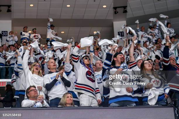 Fans wave white towels as they react to a third period goal by the Winnipeg Jets against the Vegas Golden Knights in Game Four of the First Round of...