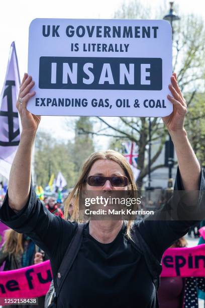 Scientist marches holding a sign criticising the UK government on the final day of four days of The Big One climate protest activities organised by...