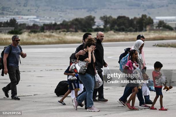 Greek nationals from Sudan arrive with a military C-27 plane at the military airport of Elefsina, south of Athens, on April 25, 2023. - Greece's...