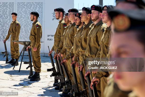 Israeli soldiers observe a two-minute silence in tribute to the fallen soldiers and victims of terrorist attacks at the Armoured Corps Memorial to...