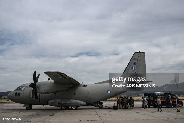 Greek nationals from Sudan arrive with a military C-27 plane at the military airport of Elefsina, south of Athens, on April 25, 2023. - Greece's...