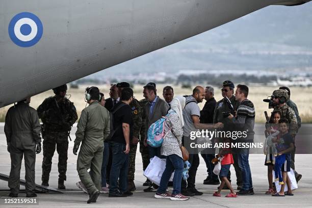 Greek nationals from Sudan arrive with a military C-27 plane at the military airport of Elefsina, south of Athens, on April 25, 2023. - Greece's...