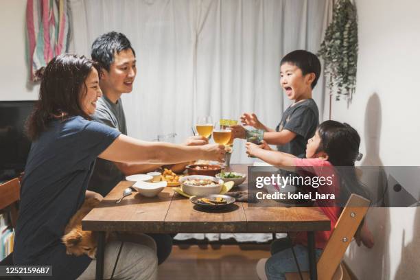 family having dinner at home - family dinner table stock pictures, royalty-free photos & images