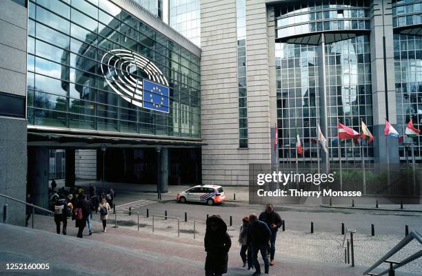 Visitors walks on the stairs in front of the Paul-Henri-Spaak building designed by Michel Boucquillon on April 24, 2023 in Brussels, Belgium. The...