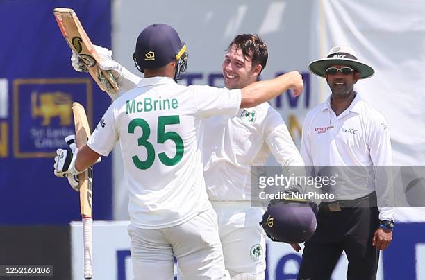 Curtis Campher celebrates with Andy McBrine of Ireland after he scored a century during the second day of the second Test match between Sri Lanka and...