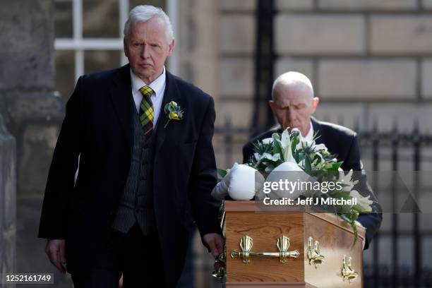 White boxing gloves lie on the coffin as it arrives for the funeral ceremony of Ken Buchanan at St Giles’ Cathedral on April 25, 2023 in Edinburgh,...