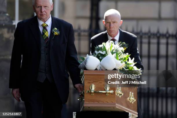 White boxing gloves lie on the coffin as it arrives for the funeral ceremony of Ken Buchanan at St Giles’ Cathedral on April 25, 2023 in Edinburgh,...