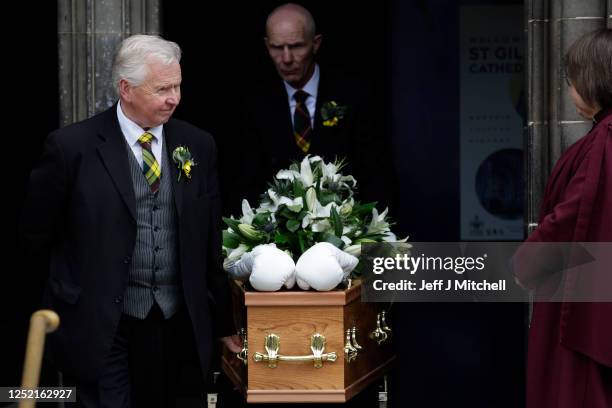 White boxing gloves lie on the coffin as it leaves the funeral ceremony of boxer Ken Buchanan at St Giles’ Cathedral on April 25, 2023 in Edinburgh,...