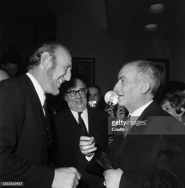 French actors Bourvil and Louis de Funès joke on March 22, 1968 at the premiere of "The Little Bather" directed by Robert Dhéry and starring de Funès...