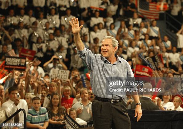 US President George W Bush Waves To The Cheering Crowd Inside The us-president-george-w-bush-waves-to-the-cheering-crowd-inside-the