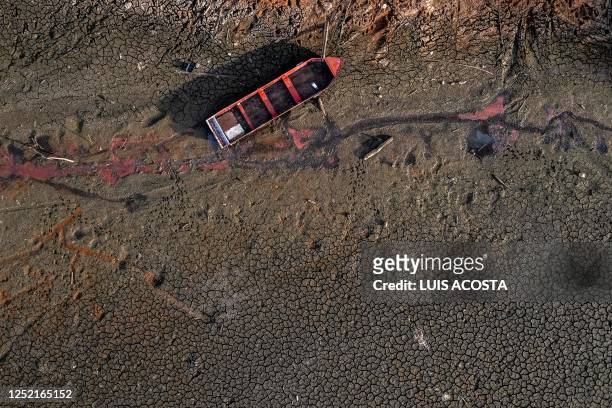 Aerial view showing a boat stranded in the dried bed of Alhajuela Lake during the summer drought, in the Colon province, 50 km north of Panama City,...