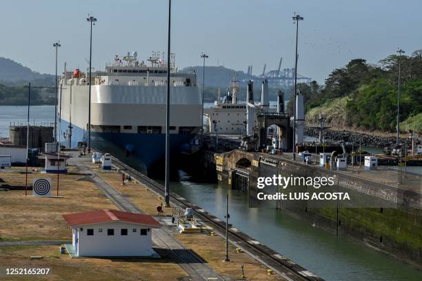 Ship is guided through the Panama Canal's Miraflores locks near Panama City on April 24, 2023. - The scarcity of rainfall due to global warming has...