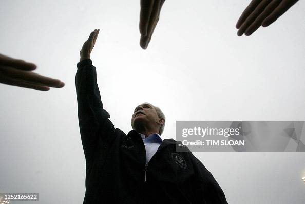 President George W. Bush waves to supporters after a campaign rally ...