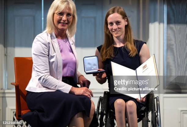 April 2023, Bavaria, Munich: Ulrike Scharf , Bavarian Minister of Social Affairs, awards Anna Schaffelhuber-Kaiser the Bavarian State Medal for...
