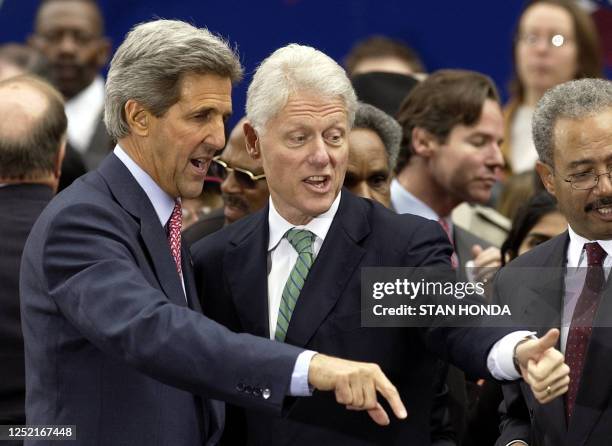 Former US president Bill Clinton, flanked by US Democratic presidential candidate Sen. John Kerry , gives the thums-up to a supporter at the end of a...