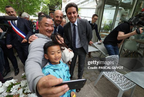 France's Junior Minister for Public Accounts Gabriel Attal and France's Minister for Transformation and Public Services Stanislas Guerini pose for a...