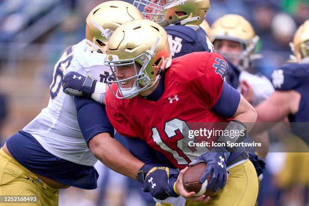 Tyler Buchner is sacked during the Notre Dame Blue-Gold Spring Football Game at Notre Dame Stadium on April 22, 2023 in South Bend, Indiana.