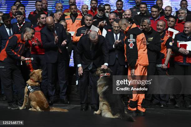 Turkish President Recep Tayyip Erdogan pets a search and rescue dog during The Ceremony of Presidential Medal and Order of Distinguished Humanitarian...