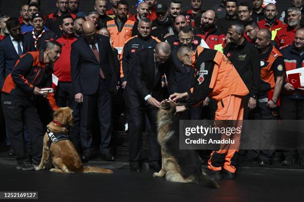 Turkish President Recep Tayyip Erdogan pets a search and rescue dog during The Ceremony of Presidential Medal and Order of Distinguished Humanitarian...