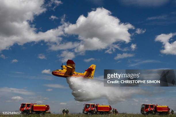 Canadair sprays water during a demonstration of civil security forest firefighting equipment at their base the airport of Nimes-Garons, southern...