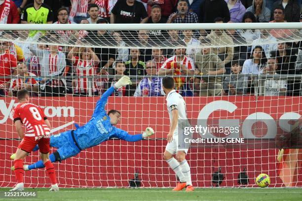 Real Madrid's Ukrainian goalkeeper Andriy Lunin concedes the opening goal scored by Girona's Argentinian forward Taty Castellanos during the Spanish...