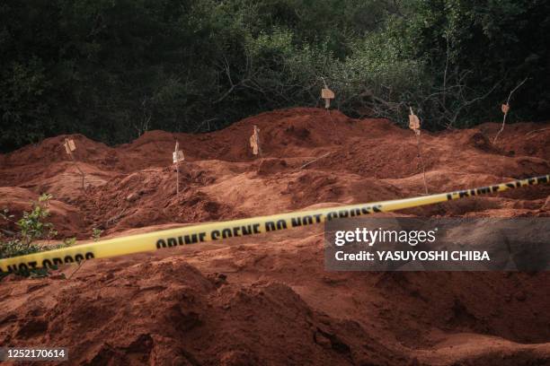 Digged holes are seen after exhuming bodies at the mass-grave site in Shakahola, outside the coastal town of Malindi, on April 25, 2023. - Kenyan...