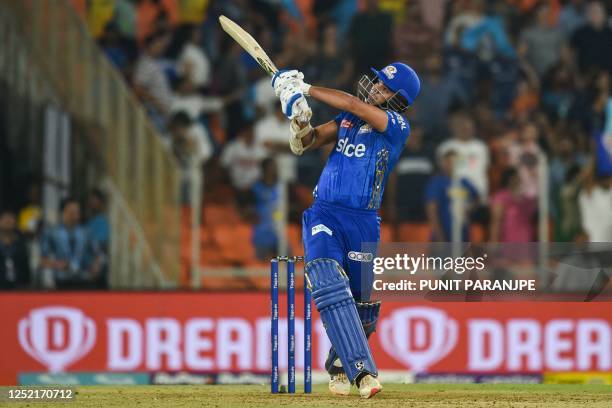 Mumbai Indians' Arjun Tendulkar plays a shot during the Indian Premier League Twenty20 cricket match between Gujarat Titans and Mumbai Indians at the...