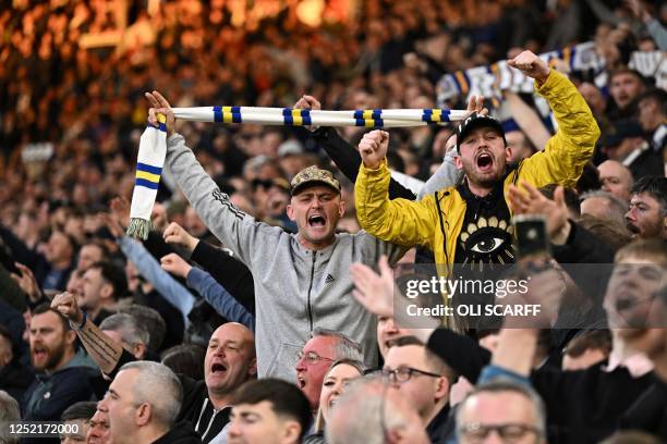 Leeds' supporters cheer prior to the start of the English Premier League football match between Leeds United and Leicester at Elland Road in Leeds,...