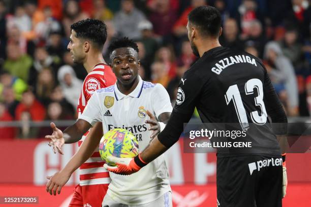 Girona's Argentinian goalkeeper Paulo Gazzaniga hands the ball to Real Madrid's Brazilian forward Vinicius Junior during the Spanish league football...