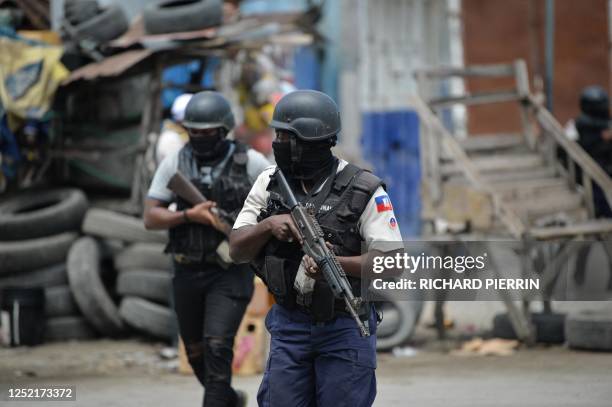 Police officers patrol a neighborhood amid gang-related violence in downtown Port-au-Prince on April 25, 2023. - Between April 14 and 19, clashes...