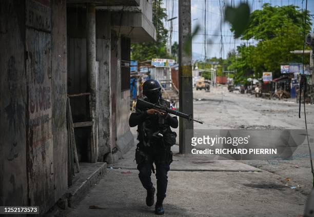 Police officers patrol a neighborhood amid gang-related violence in downtown Port-au-Prince on April 25, 2023. - Between April 14 and 19, clashes...