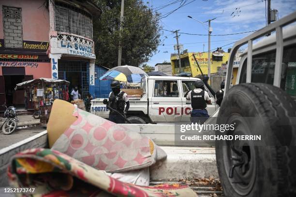 Police officers patrol a neighborhood amid gang-related violence in downtown Port-au-Prince on April 25, 2023. - Between April 14 and 19, clashes...