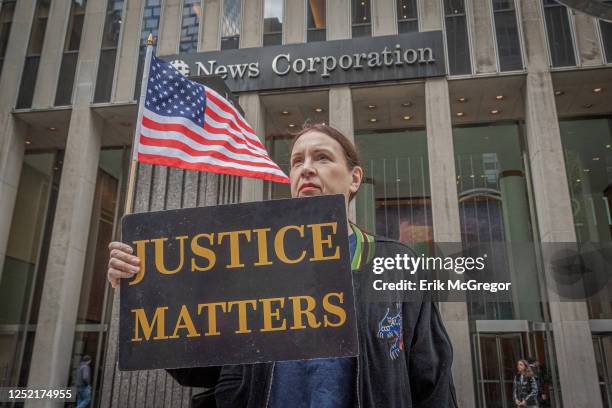 Participant seen holding a sign outside Fox News HQ. In the wake of the settlement with Dominion Voting Systems, the firing of Fox's anchor Tucker...