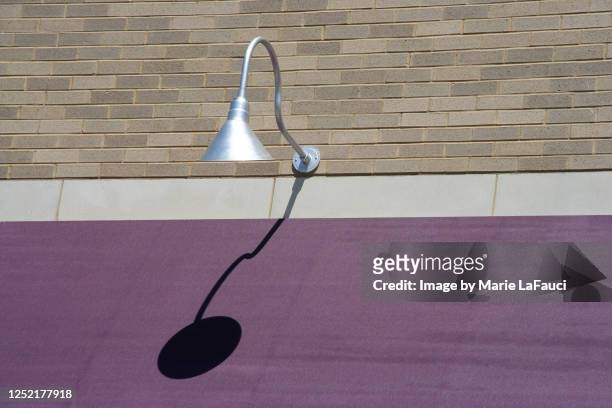 outdoor lighting fixture with purple awning - brick wall brass stock pictures, royalty-free photos & images