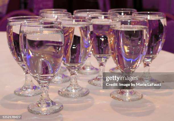 ten glasses on table filled with water - ten of clubs bildbanksfoton och bilder