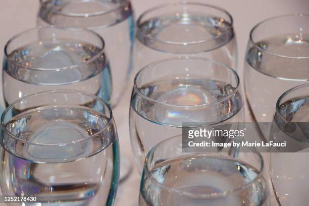 close-up of drinking glasses filled with water - dining overlooking water stock pictures, royalty-free photos & images