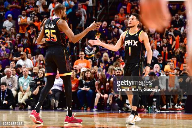 Devin Booker of the Phoenix Suns high fives Kevin Durant of the Phoenix Suns during the game against the LA Clippers during Round 1 Game 5 of the...