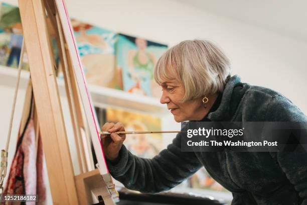 Rebecca Chopp paints in her basement home studio on February 24, 2023. Rebecca was formerly chancellor of the University of Denver when she was...